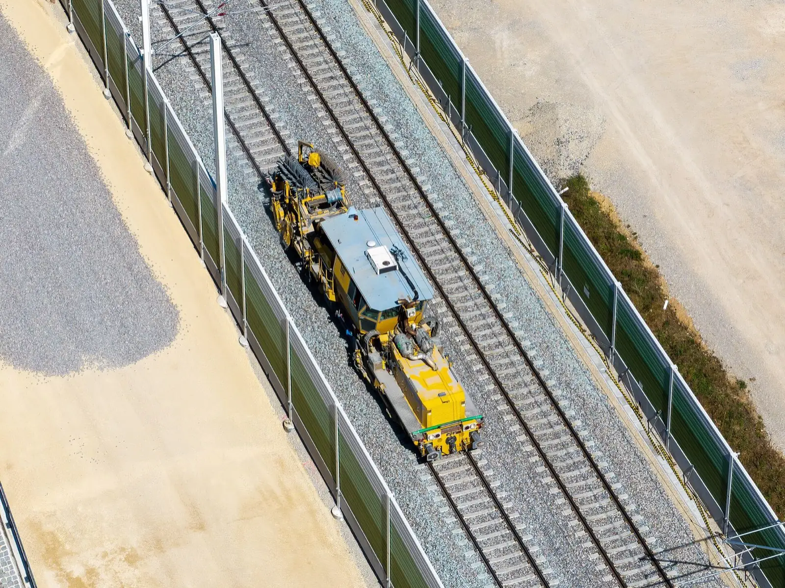 Aerial view of a production tamping machine on a track reconstruction site